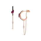 Pair of 18kt rose gold linear drop earrings featuring pear-cut rubies, black diamond pavé accents, and a delicate gold chain with a bezel-set white diamond