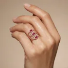 Alma Ring in pink gold with marquise rubies and diamond halo pavé bands