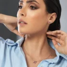 Model wearing Arrow multi color sapphire diamond stud earrings in 18kt rose gold with pear-shaped sapphires and sparkling diamonds