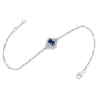 Celeste Bracelet in white gold with a central oval blue sapphire and diamond halo