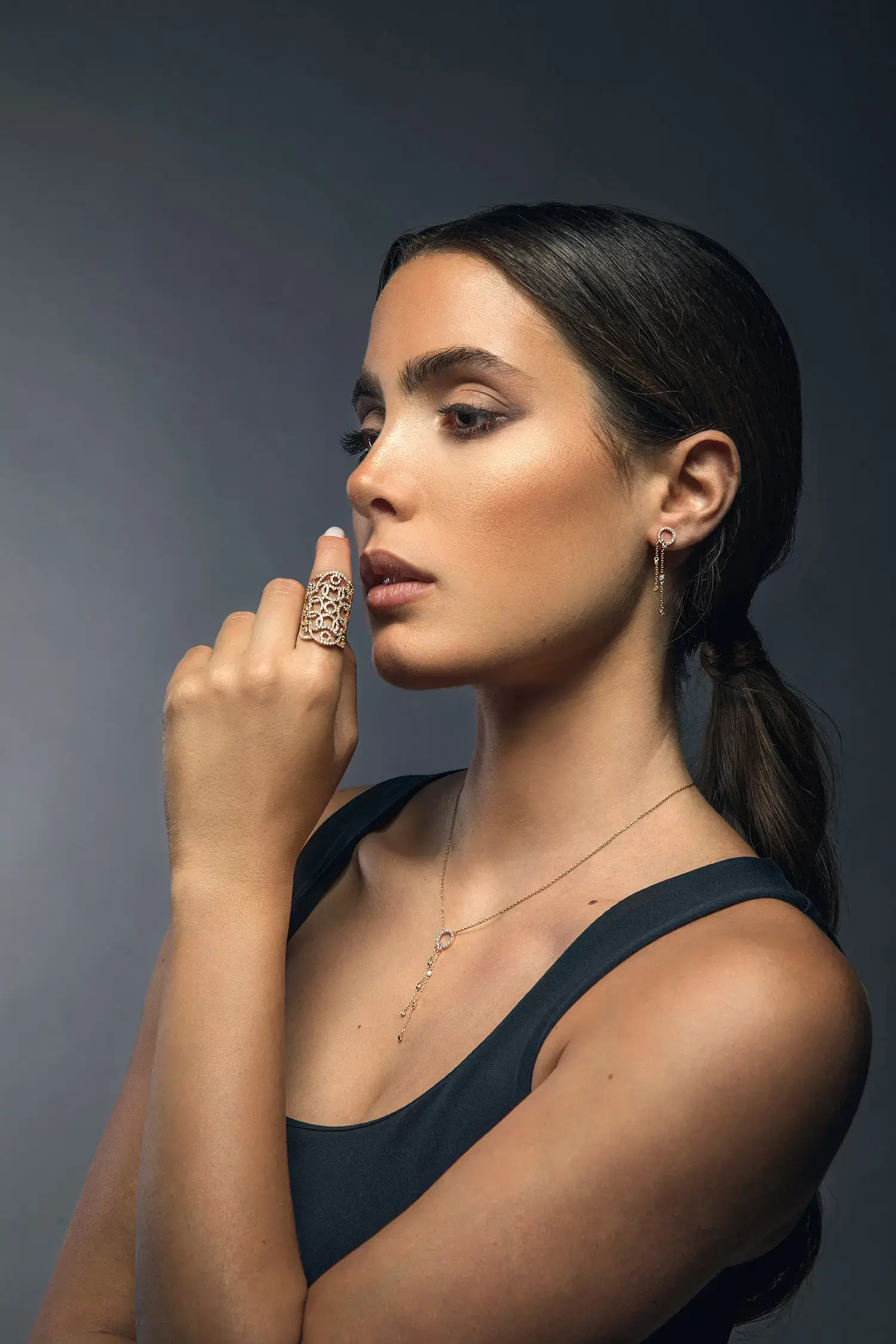 Model wearing Cercle diamond circle drop earrings in 18kt rose gold with delicate chain drops and diamond details