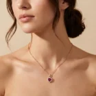 Coeur Pendant in pink gold with a heart-shaped ruby and diamond halo