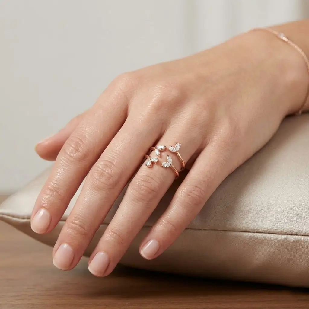 Oito Ring in pink gold with marquise and pear-shaped diamonds in an open wrap design