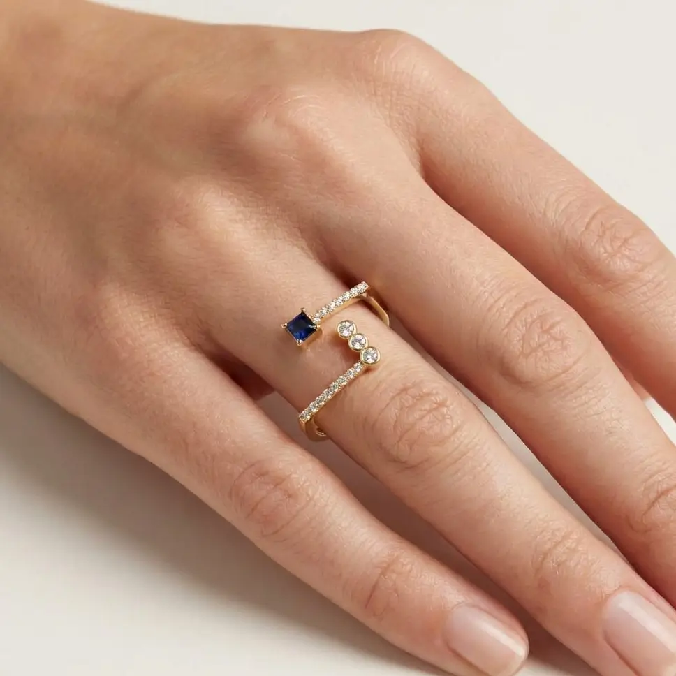 Oria Ring in yellow gold with a square blue sapphire and diamond accents