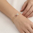 Rosera Bracelet in yellow gold with a ruby and diamond halo details