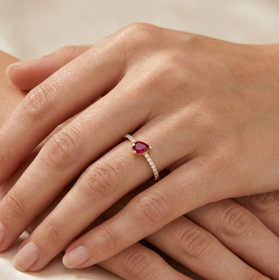 Velina Ring in yellow gold with a pear-shaped ruby and pavé diamond band