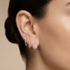 Stellara Earrings in pink gold with diamond accents and a sculpted starburst design