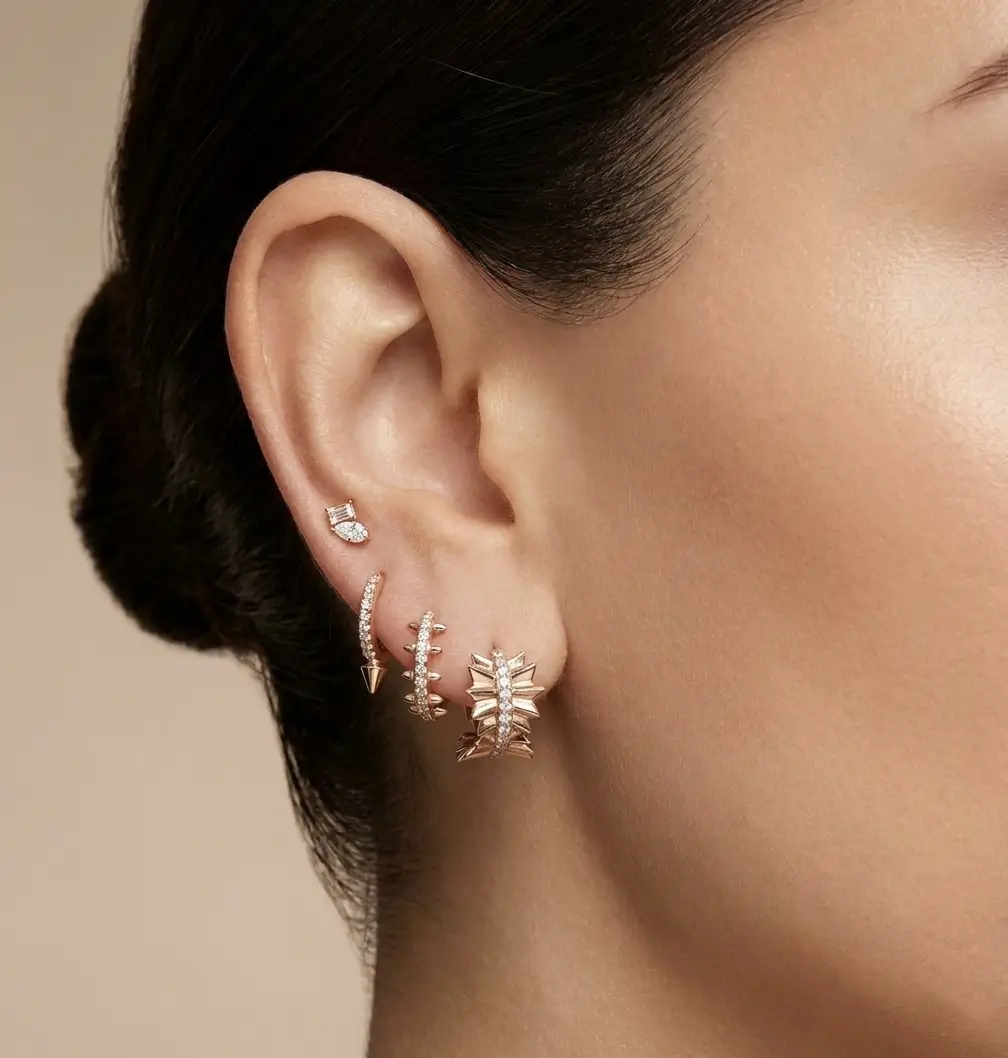 Stellara Earrings in pink gold with diamond accents and a sculpted starburst design